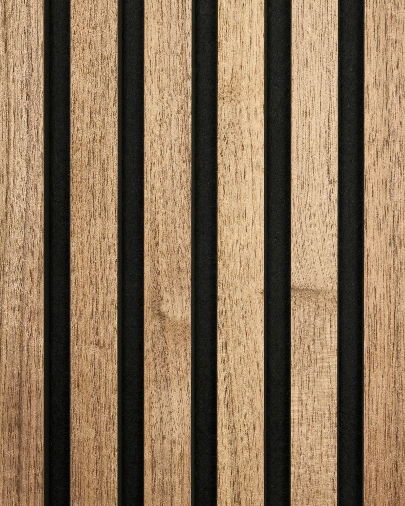 Close-up of WoodUpp Akupanel sample in walnut finish, featuring vertical wooden slats and black felt backing for a modern striped acoustic panel look.