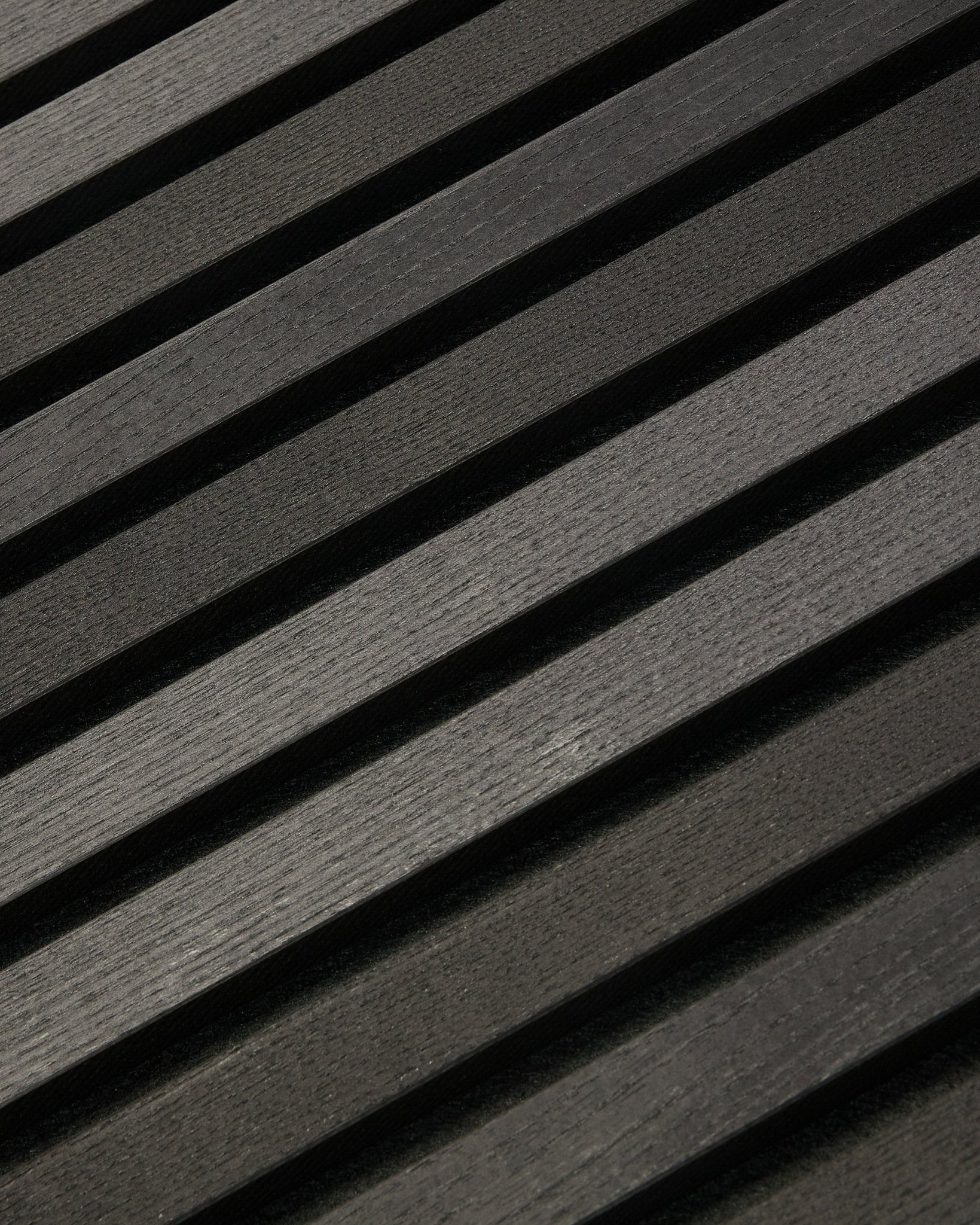 Tonal Akupanel in Black Ash (300 x 60 cm) by WoodUpp, a dark diagonal acoustic panel with textured, Scandinavian-inspired slats for interior walls.