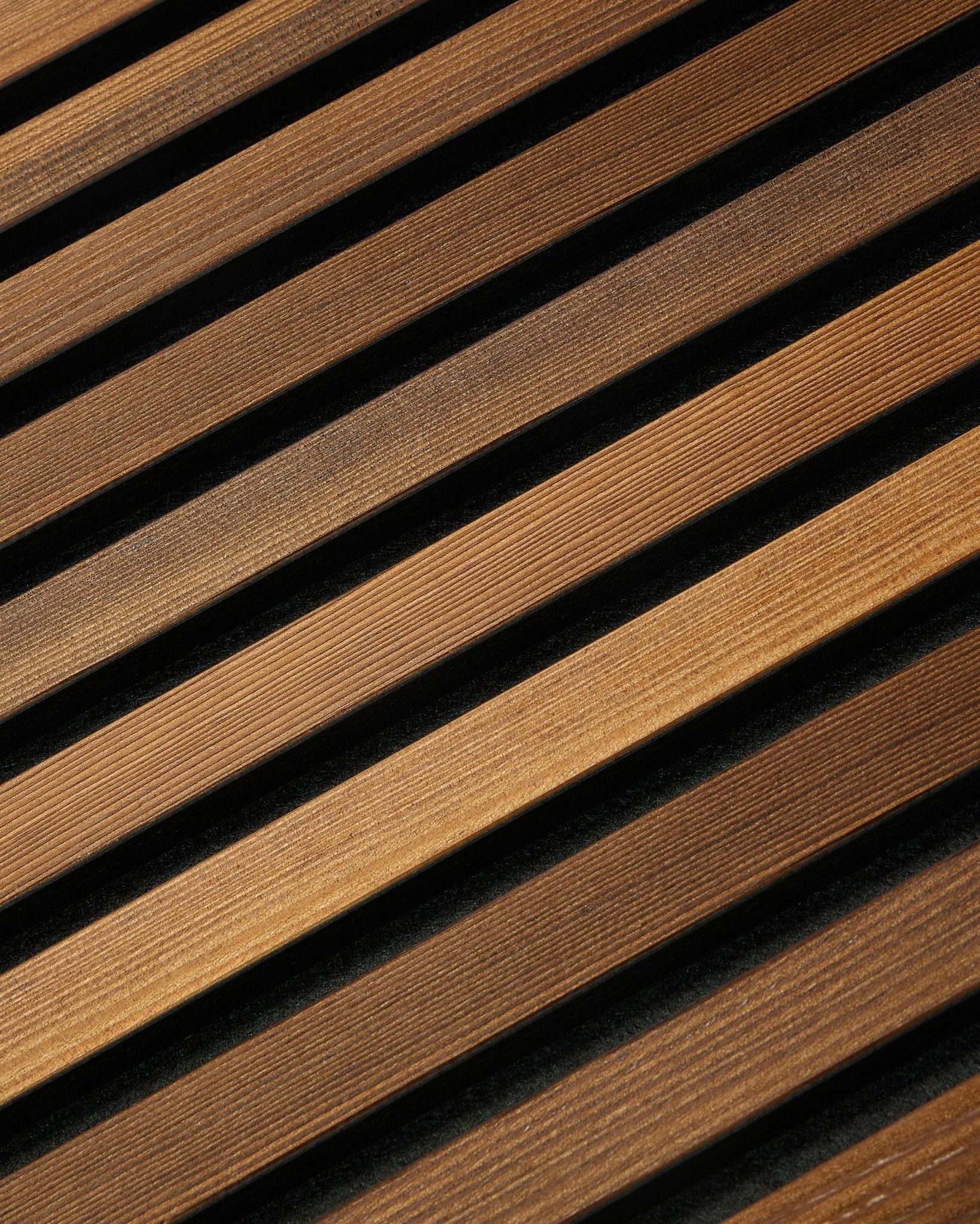 WoodUpp Akupanel Rustic in Smoked Larch (240x60 cm) features diagonal brown acoustic slats creating a striped Nordic look with subtle shadowed detailing.