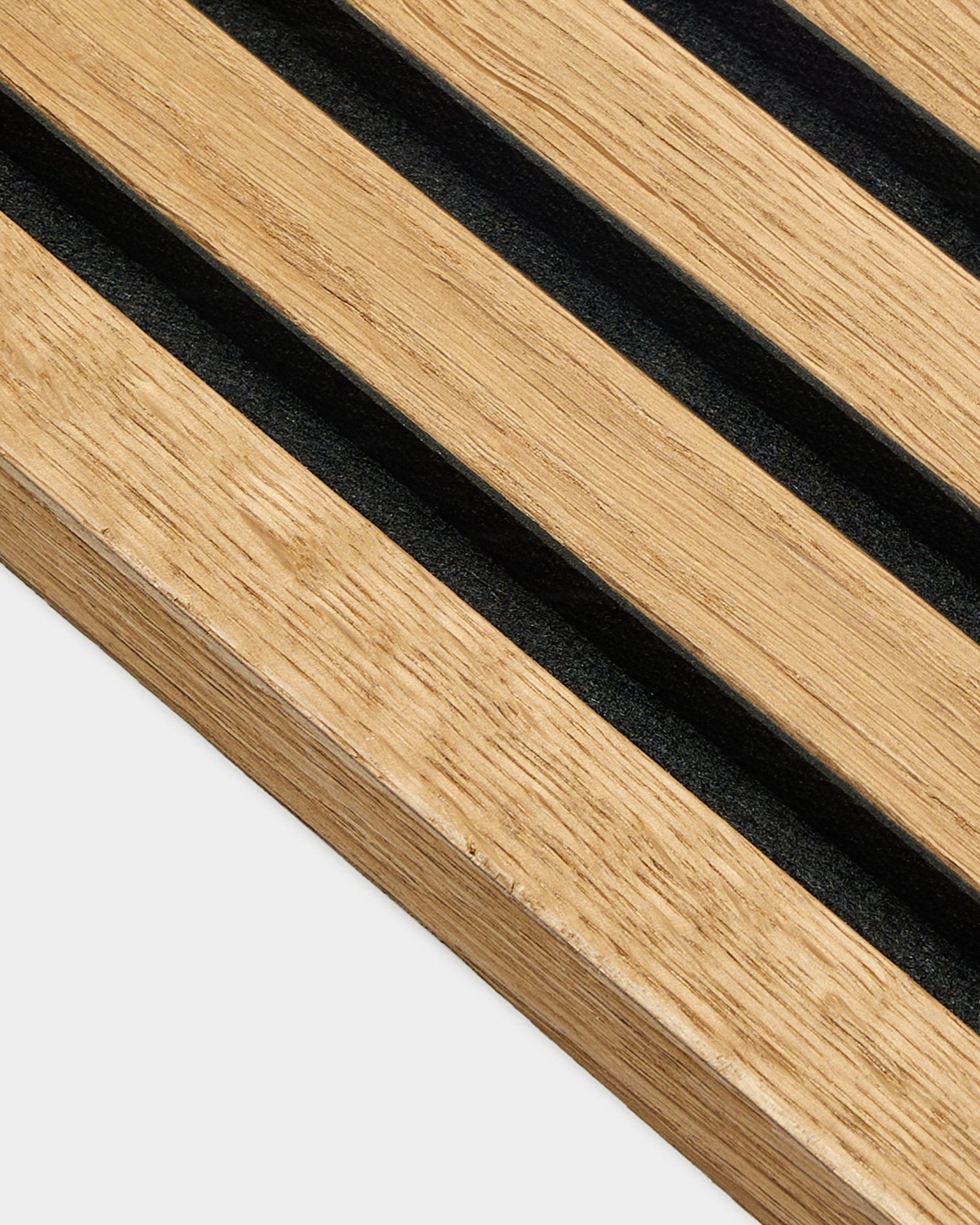 Close-up of WoodUpp End Lamella panel in Rustic Brown Oak (2.2 cm), designed for Akupanel acoustic installs with evenly spaced slats on a light wall.