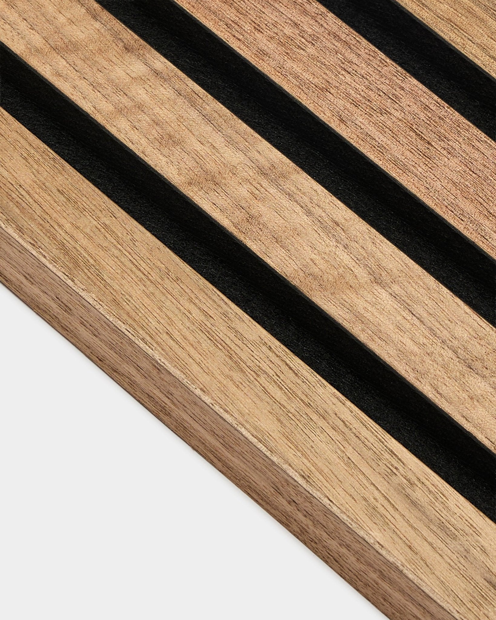 Close-up of WoodUpp Akupanel End Lamella in walnut, 2.2 cm acoustic panel featuring parallel black stripes and visible walnut wood grain on white background.