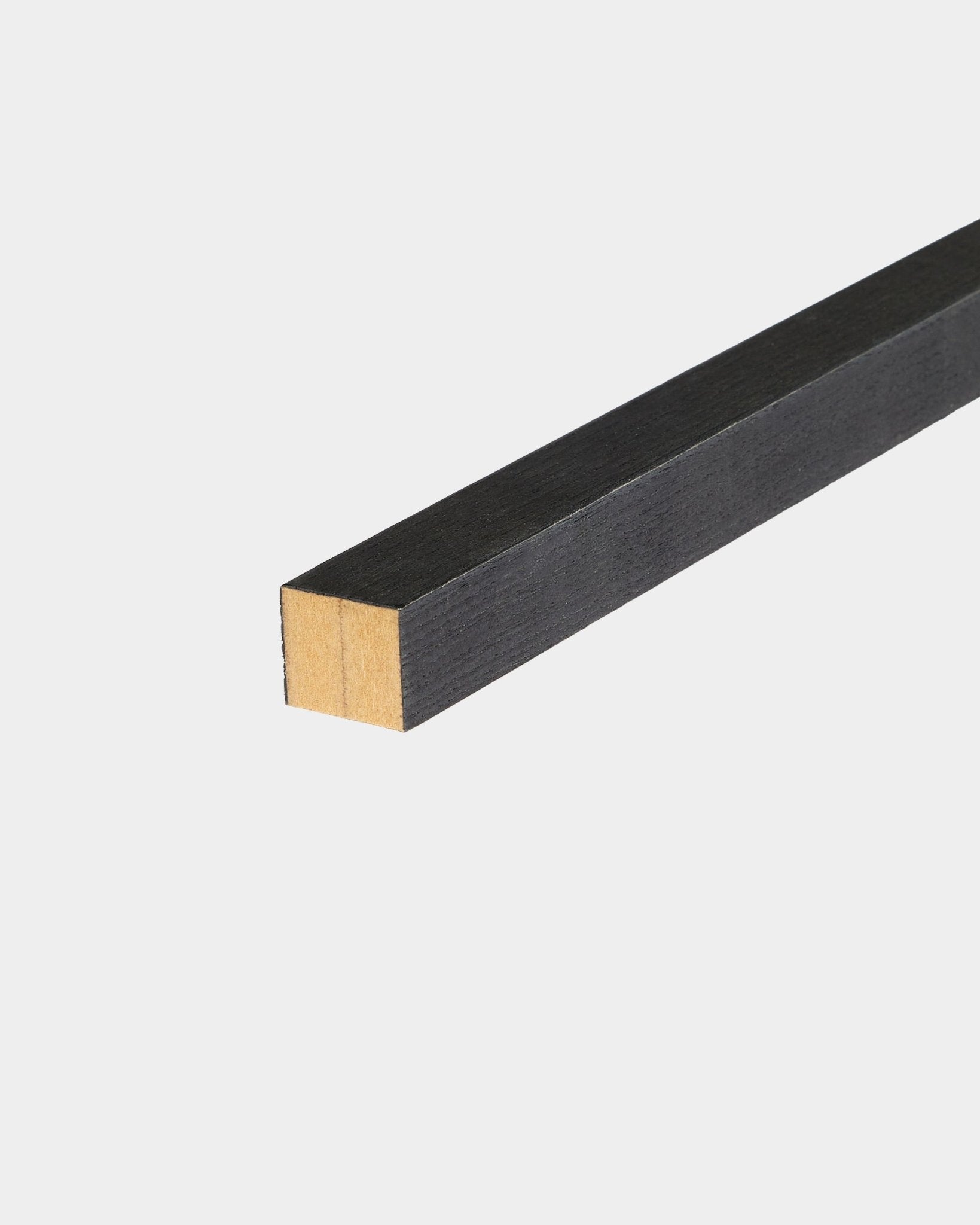 WoodUpp Black Ash End Lamella, 2.2 cm, designed for Akupanel acoustic panel installation, resting on a white surface with one end unfinished.