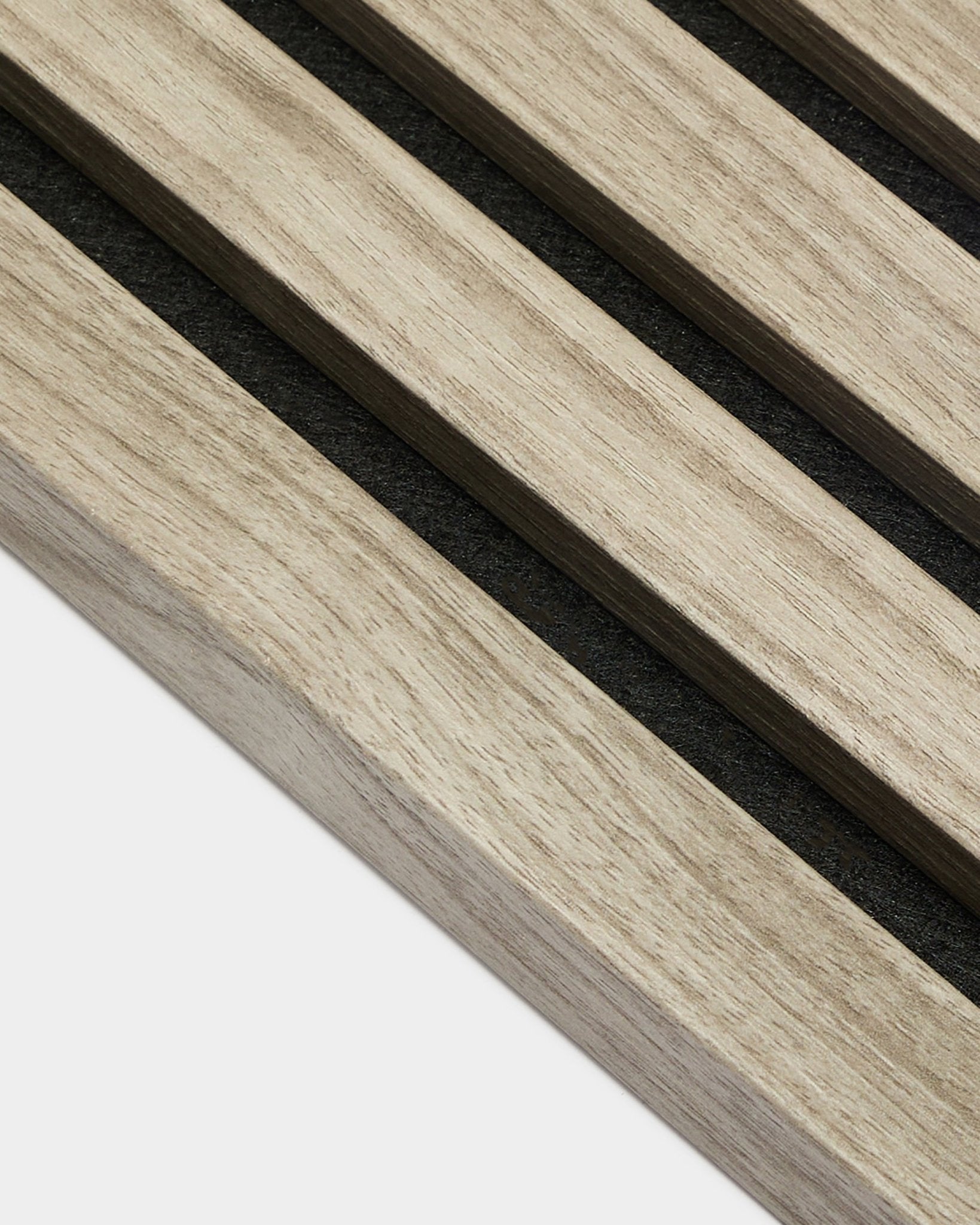 Close-up of WoodUpp Akupanel End Lamella in Weathered Oak, 2.2 cm—light Nordic oak acoustic slats with black felt backing on a white background.
