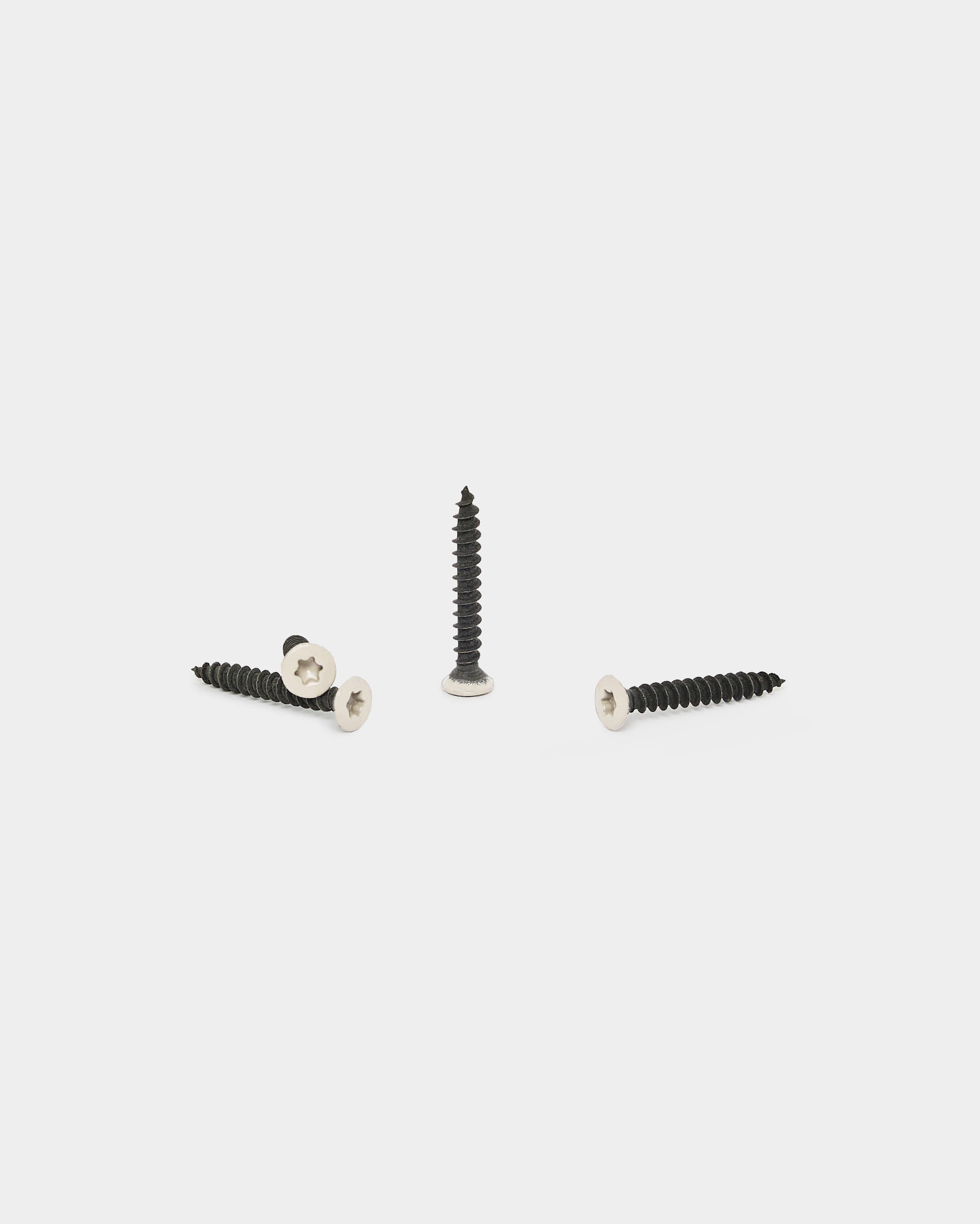 Three light beige WoodUpp screws for Akupanel acoustic panel installation, part of the 100-piece Installation Products | Screws set, displayed on a white background.