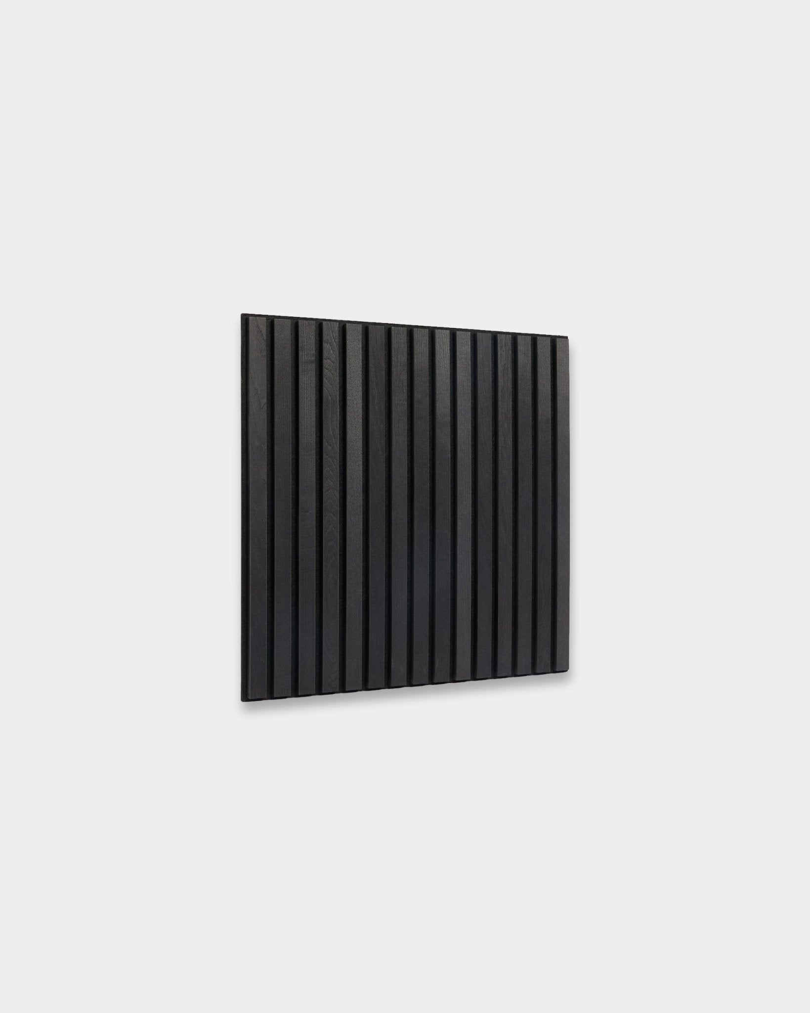 WoodUpp Akupixel Black Ash acoustic panel (60x60 cm) with vertical wood slats mounted on a light gray wall, showcasing minimalist Scandinavian design.