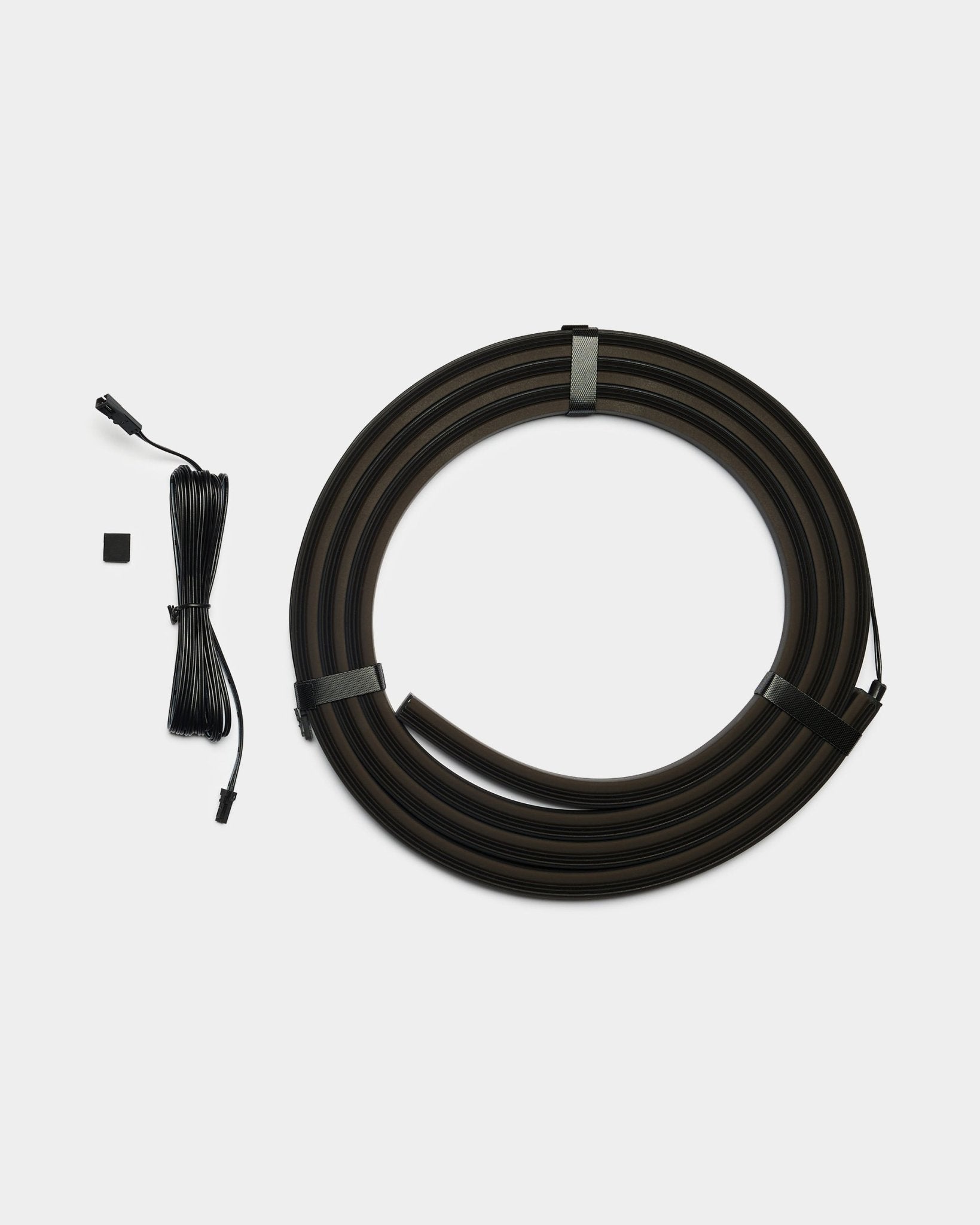 Lumi LED striplight by WoodUpp, featuring two black 240cm strips with connectors and a small component; designed for integration with acoustic panels, Philips Hue compatible.