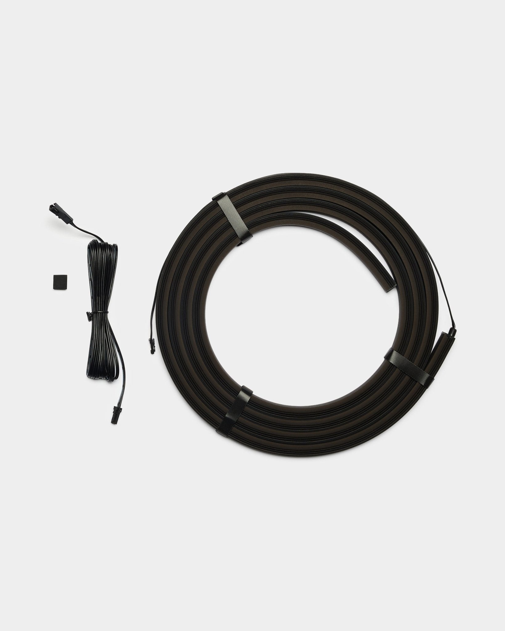 WoodUpp Lumi 300cm black LED striplight with connectors, Philips Hue compatible, includes long black cable and small black rectangular connector piece.