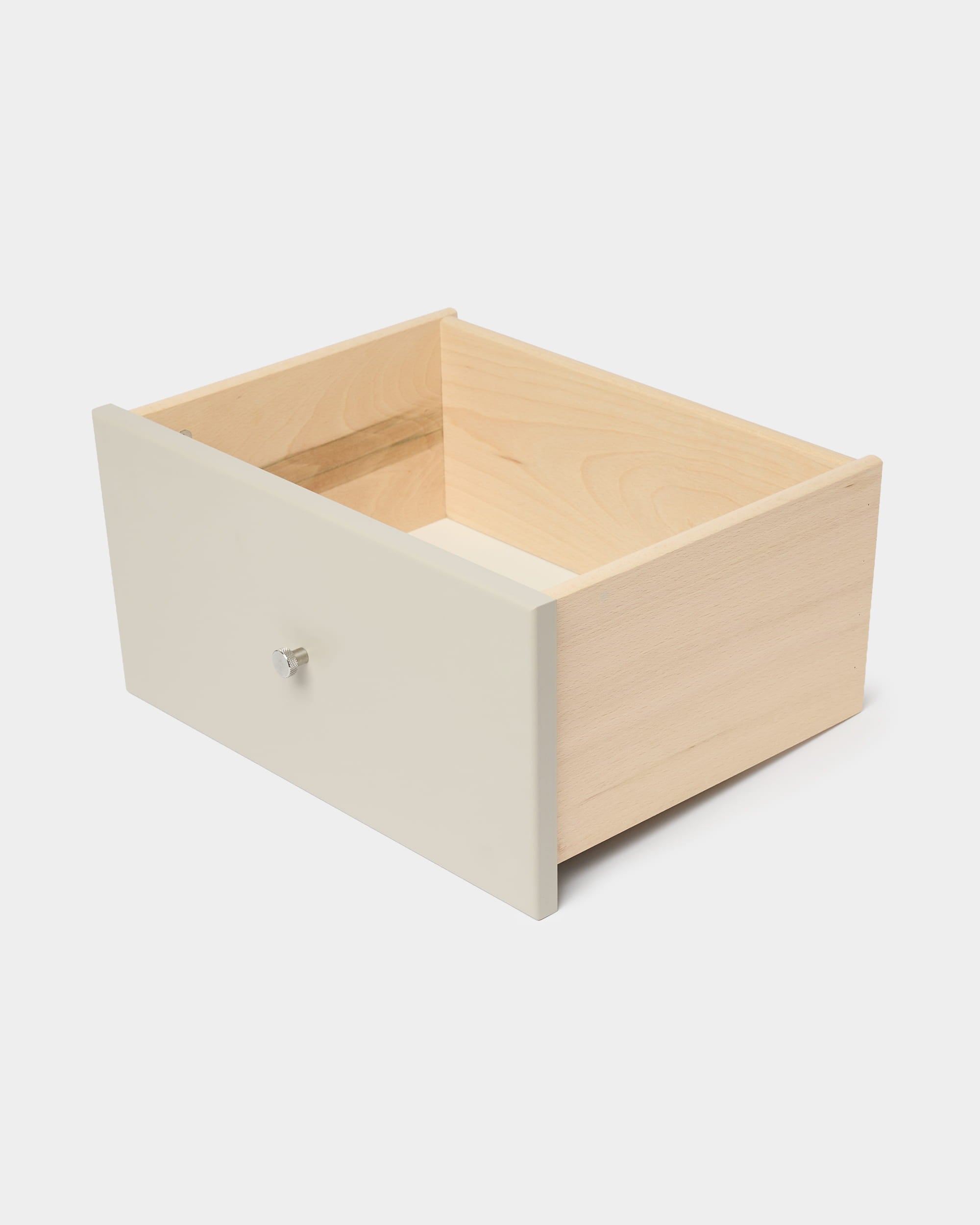 Tiroir de bibliothèque WoodUpp Arka, de couleur beige avec une façade et un bouton blancs, conçu pour un rangement fermé, présenté sur un fond blanc uni.