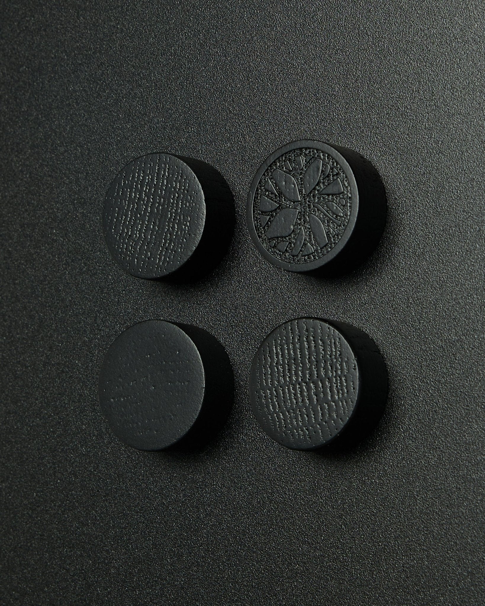 Set of 4 round black oak magnets by WoodUpp, designed for the Norr Magnetic Board. Matte finish with subtle wood texture. Suitable as Akupanel accessories.