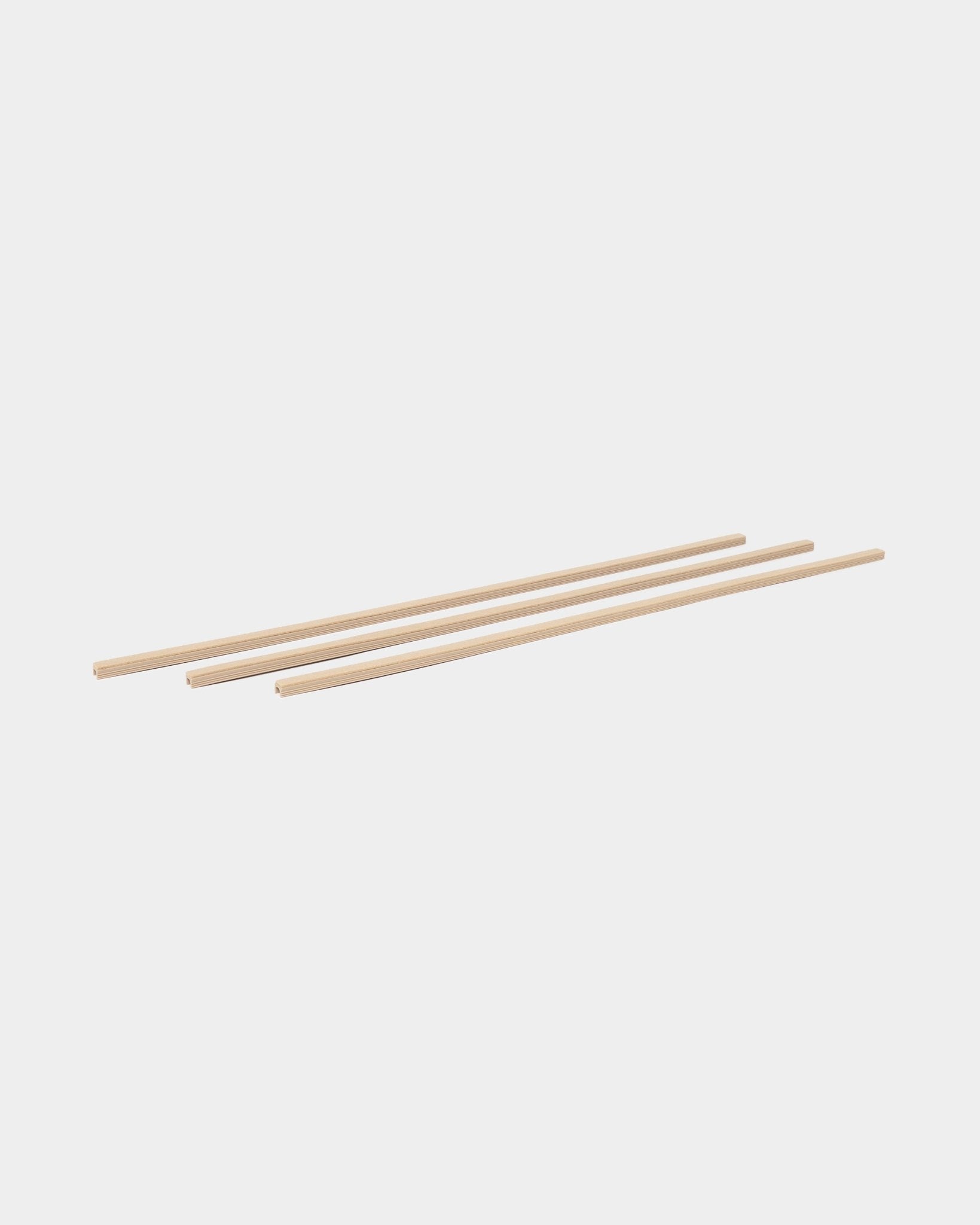 Three beige Dupps Pop-on Cable Covers (3 pieces) by WoodUpp, part of the CREATE accessories collection, arranged parallel on a white background.