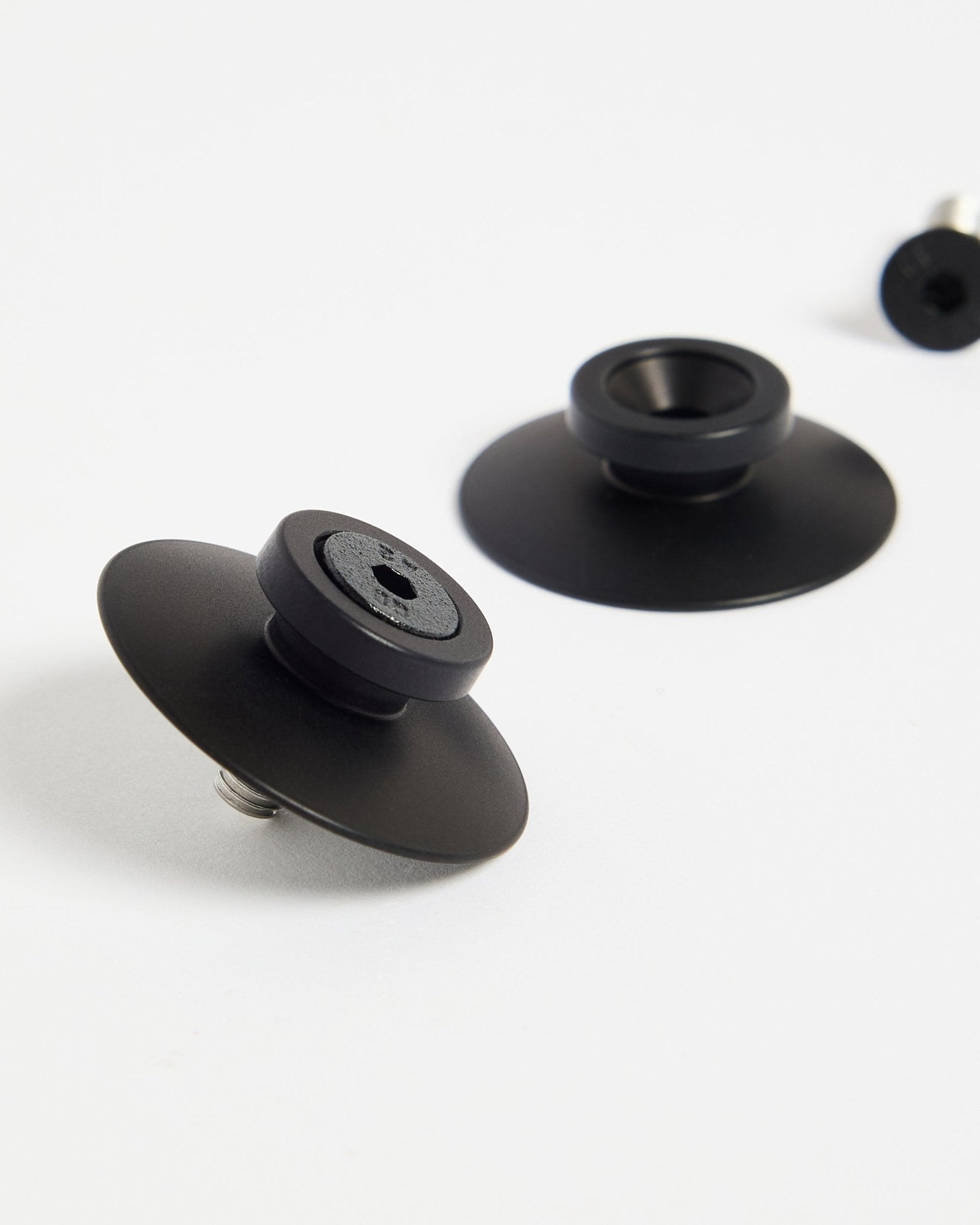 Two black aluminium WoodUpp Dupps fasteners (2 pcs) on a white surface, designed for securely mounting acoustic panels or room dividers.