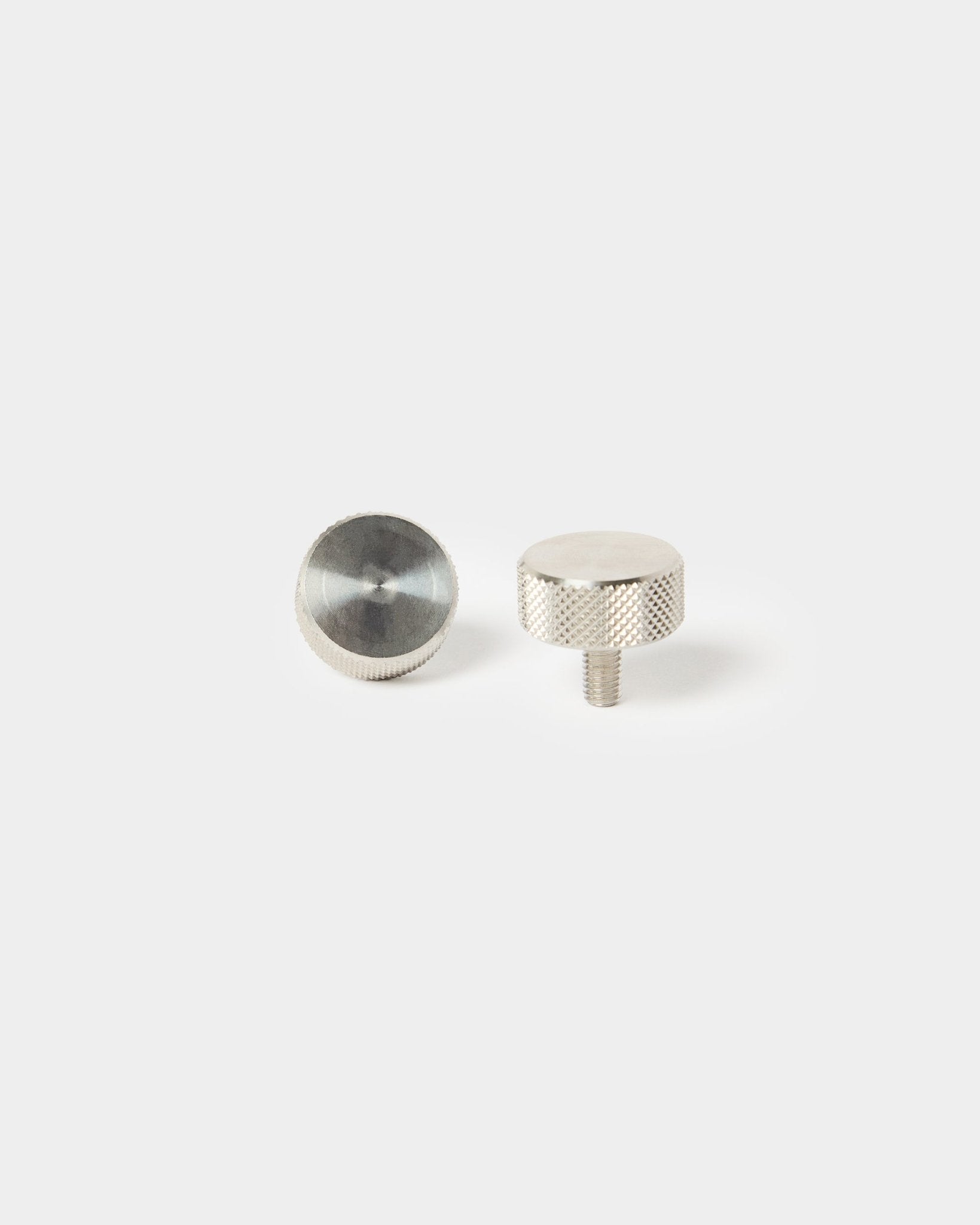 Pair of WoodUpp stainless steel finger screws (M5x10 mm, 20x8.8) for acoustic panel installation—one threaded end, one smooth top.