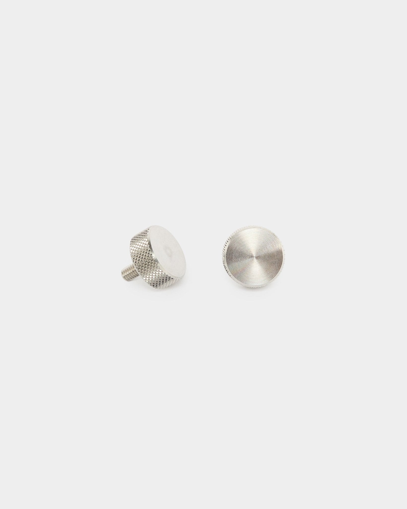 Two WoodUpp stainless steel finger screws (M5x10mm, 20x8.8), accessories for Akupanel acoustic panels, shown upright and flat on a plain white background.